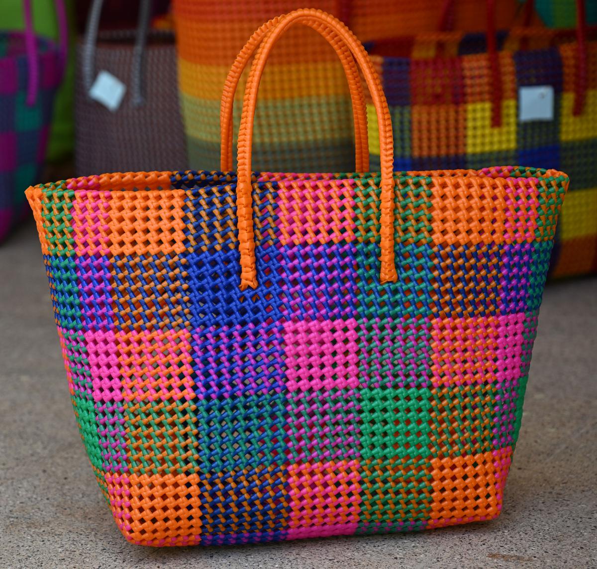 A checked pattern basket woven by Rehabilitation Centre for Blind Women artisans.