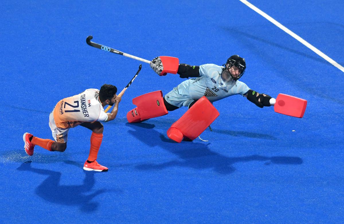 New Zealand’s  goalkeeper Leon Hayward attemps to block Shamsher’s effort during the shootout in the FIH Men’s Hockey World Cup 2023 crossover match at the Kalinga hockey stadium in Bhubaneswar on January 22, 2023. 