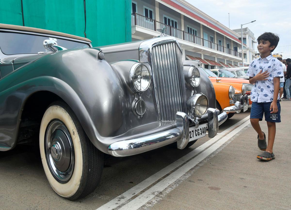 Visitors looking at the heritage cars display, organised by Historical Cars Association of India on Beach Road in Puducherry on Monday. 