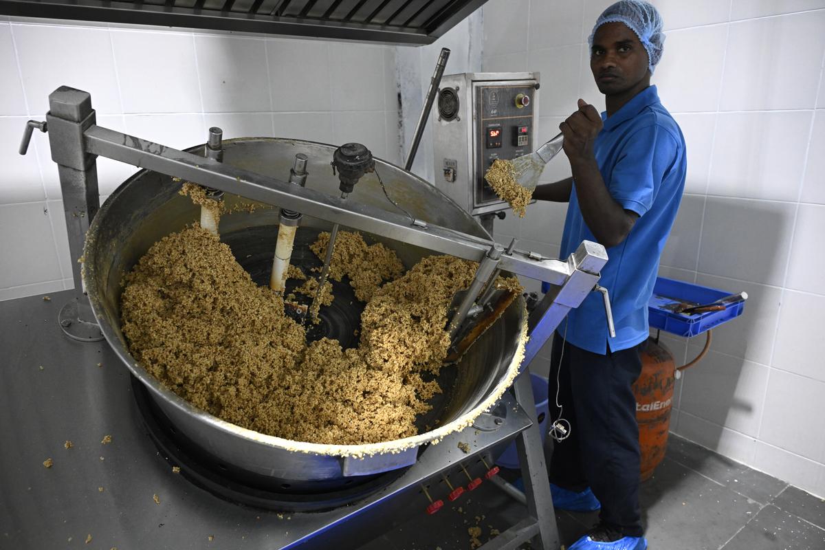 A worker at the factory rolls the mixture   