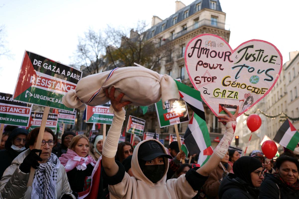 Protestors in Paris display banners reading ‘Stop Genocide in Gaza’, seeking boycott of Israel from 2024 Olympics