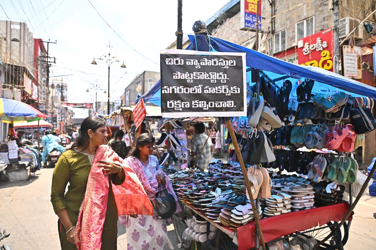 A card reading, “It’s not right to deprive the poor of their livelihood. Hawkers’ rights must be protected”, hanging from a cart on Besant Road in Vijayawada.