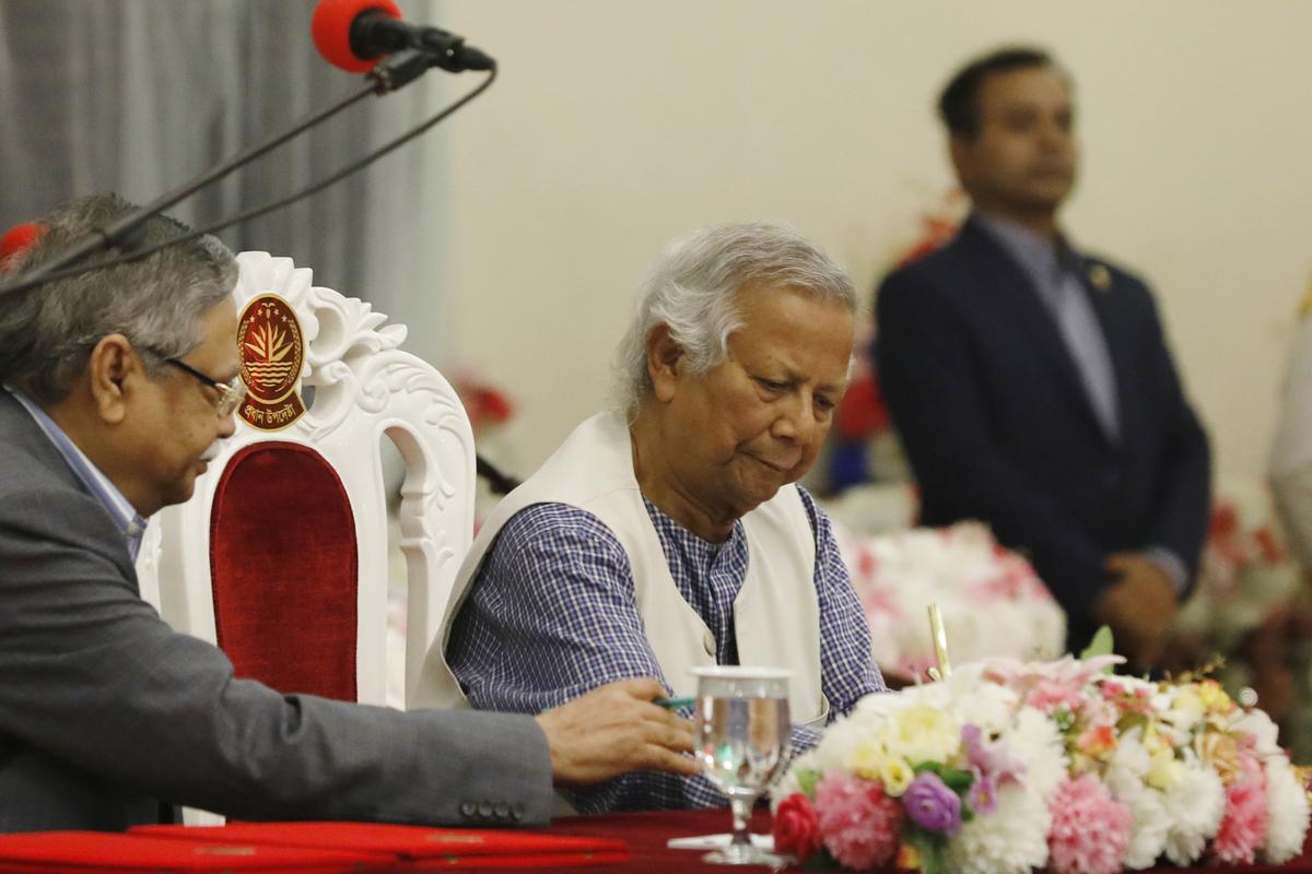 Nobel laureate Muhammad Yunus signs a document after taking oath of office as the head of Bangladesh’s interim government in Dhaka on August 8, 2024. 