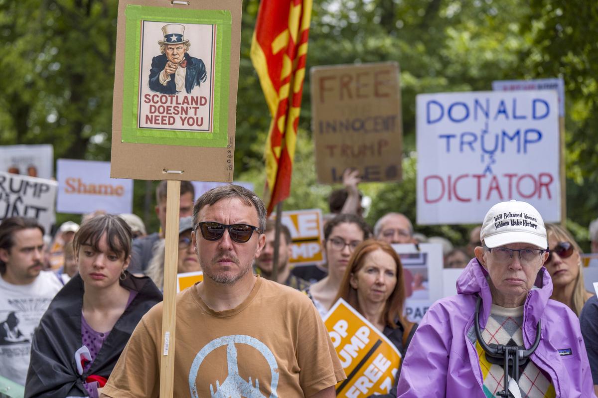People take part in a Stop Trump Scotland protest outside the U.S. Consulate in Edinburgh, as US President Donald Trump begins his five-day private trip to the country at his Turnberry golf course in South Ayrshire on Saturday, July 26, 2025. People take part in a Stop Trump Scotland protest outside the U.S. Consulate in Edinburgh, as US President Donald Trump begins his five-day private trip to the country at his Turnberry golf course in South Ayrshire on Saturday, July 26, 2025.