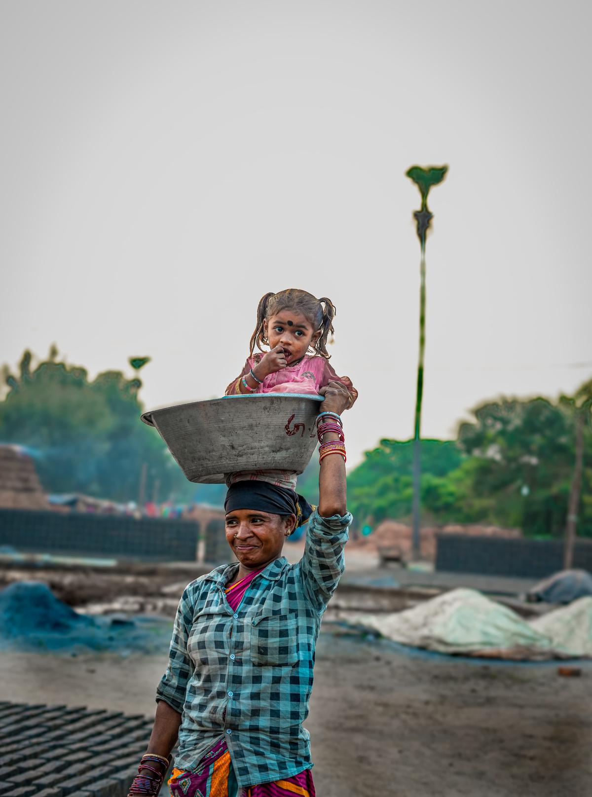 A daily wage labourer carrying her child in the tub as she heads for work. The picture taken by Kotni Deva Sahayam will be one of the exhibits at the photography exhibition in Andhra University in Visakhapatnam.