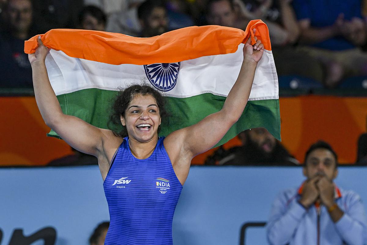 India’s Sakshi Malik holds the tricolor after winning against Canada’s Ana Godinez Gonzalez in the final of the Women’s Freestyle Wrestling 62kg category event at the Commonwealth Games 2022 in Birmingham on August 5, 2022. 