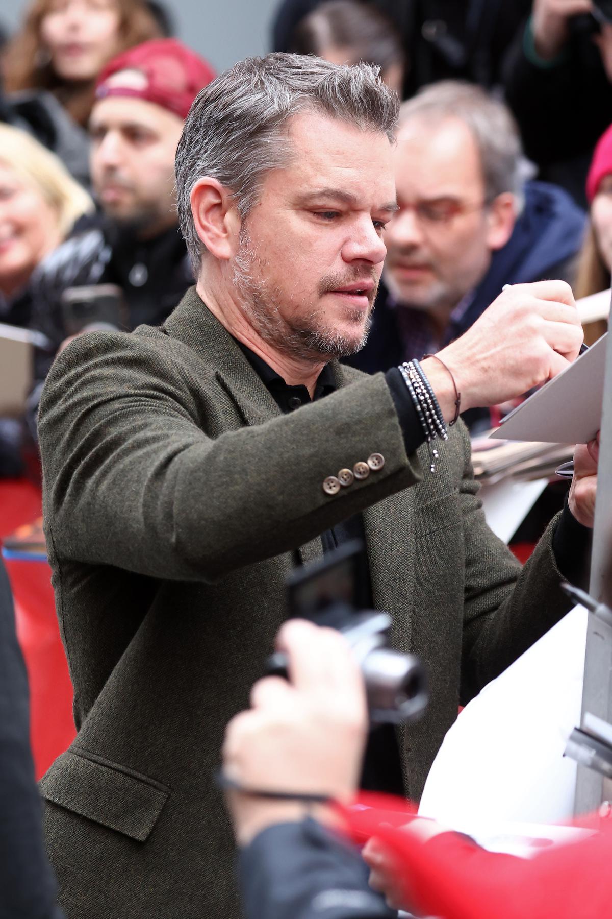 Matt Damon writes autographs as he arrives for the ‘Small Things Like These’ photocall during the 74th Berlinale International Film Festival Berlin 