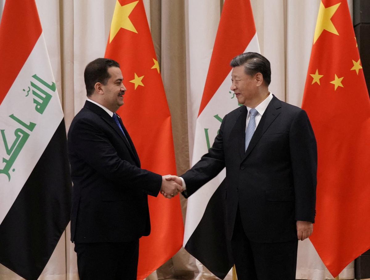 Iraqi Prime Minister Mohammed Shia al-Sudani shakes hands with Chinese President Xi Jinping in Riyadh, Saudi 