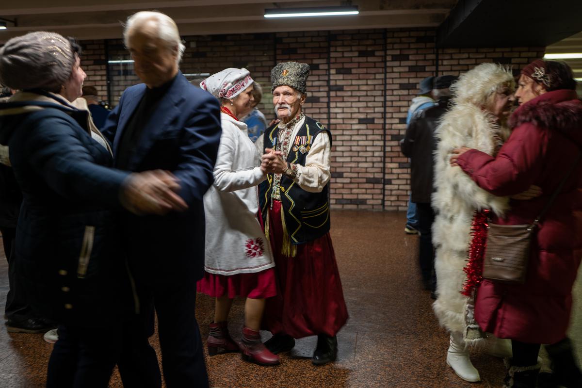 Elderly couples participate in an ongoing traditional dance gathering in an underground mall on January 01, 2023 in Kyiv, Ukraine.