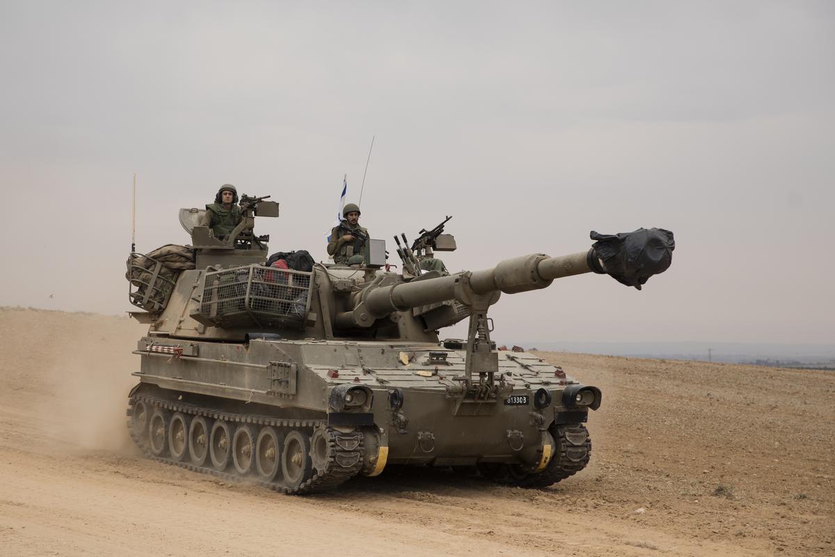 An Israeli tank drives toward the Israeli southern border with the Gaza Strip  near Sderot, Israel. on October 9, 2023.