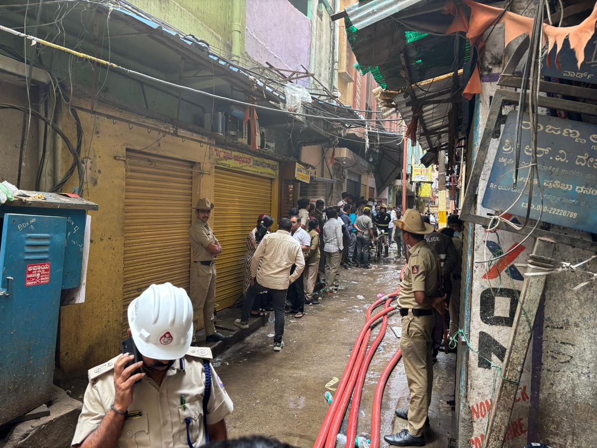  Police and fire service officers at the site where a fire broke out in a plastic manufacturing unit at Nagarthapete in Bengaluru on August 16, 2025. 