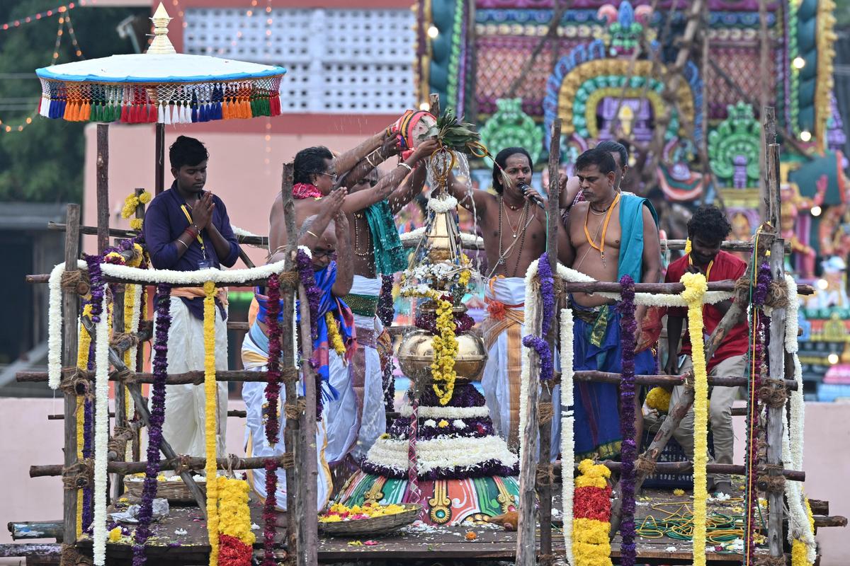 Priests perform the Maha Kumbabhishekam at Aathi Kumbeshwarar Temple in Kumbakonam, Thanjavur, on Monday as devotees throng the temple complex to witness the consecration ritual. 
