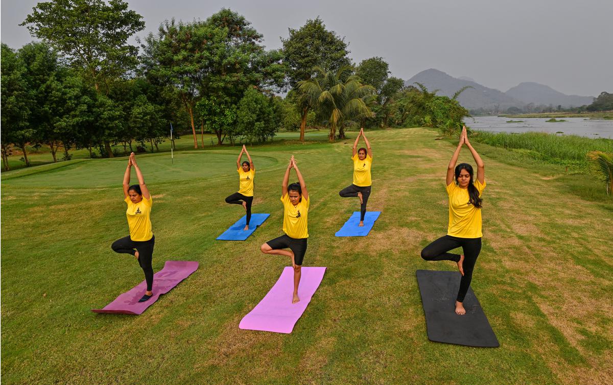 Visitors enjoying in a yoga session on a Golf golf course on the banks of River Nagavali at Anija village in Rayagada district, Odisha.