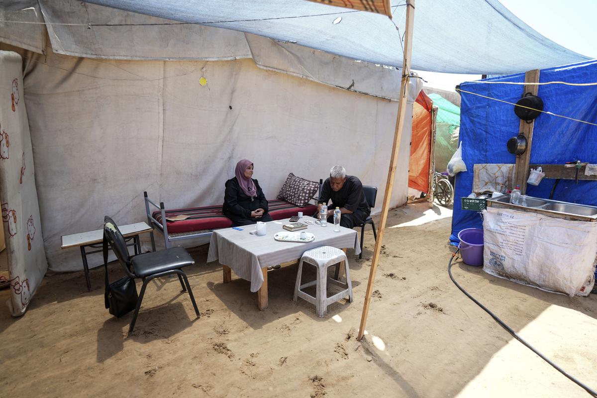 Ibrahim Abu Shaaban sits with his wife, both of whom had planned to perform the Hajj pilgrimage this year, but like all Palestinians in the coastal enclave of Gaza were not able to travel to Mecca because of the closure of the Rafah crossing in May.