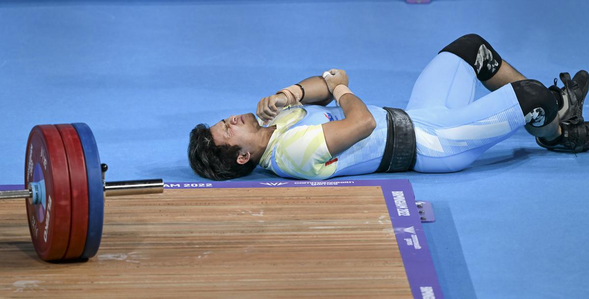 India’s Jeremy Lalrinnunga reacts after falling down after an unsuccessful attempt during the men’s 67kg category weightlifting event, at the Commonwealth Games 2022, in Birmingham on July 31, 2022.