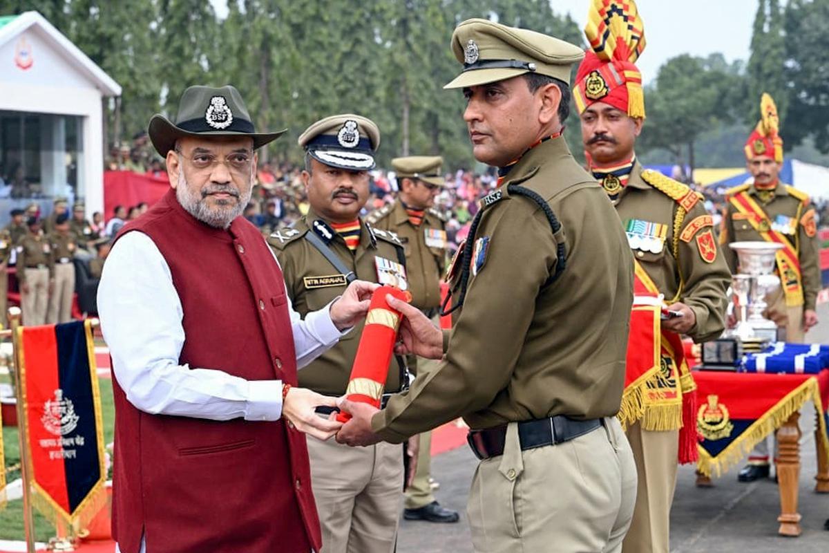 Union Home Minister Amit Shah felicitates during the 59th Raising Day of the Border Security Force (BSF), in Hazaribagh on Friday. Border Security Force (BSF) Director General Nitin Agrawal is also seen.  