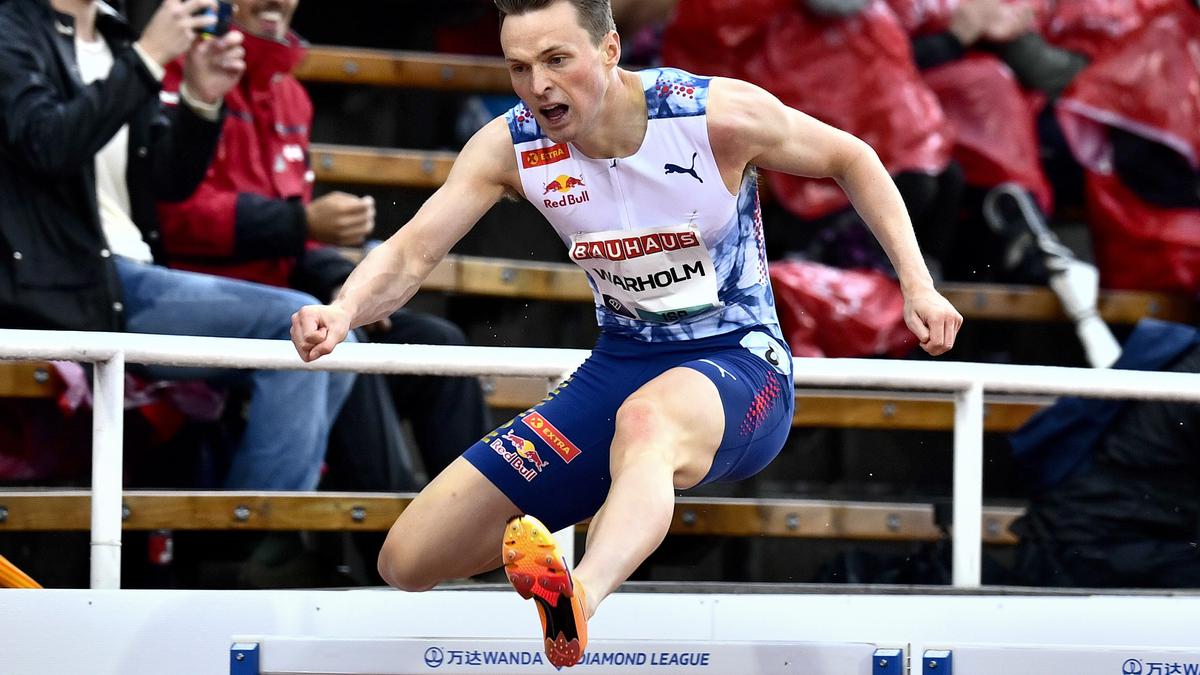 An Olympic champion boos protesters who knelt on the track near the finish line of his race