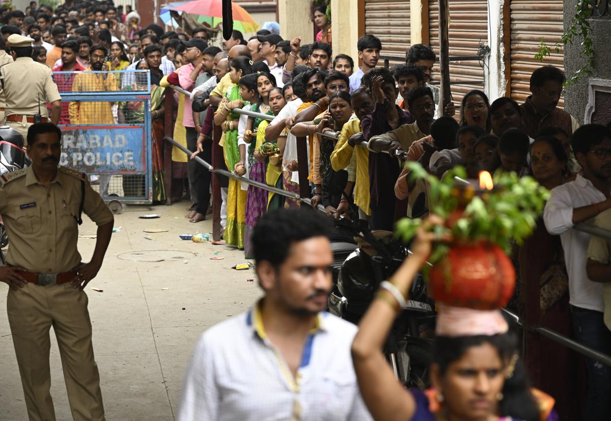Devotees waiting in queue to offer prayers to goddess Kali during Bonalu festival at Lal Darwaza Simhavahini Mahankali Temple in Hyderabad on Sunday. Devotees waiting in queue to offer prayers to goddess Kali during Bonalu festival at Lal Darwaza Simhavahini Mahankali Temple in Hyderabad on Sunday.
