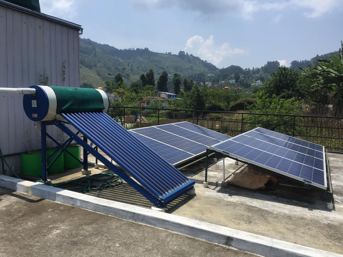 Solar panels for powering, and solar water heating system in the foreground.