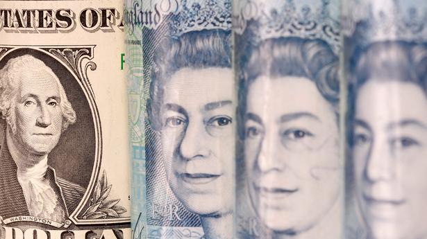 Pound jumps against dollar on UK tax U-turn, weak US data