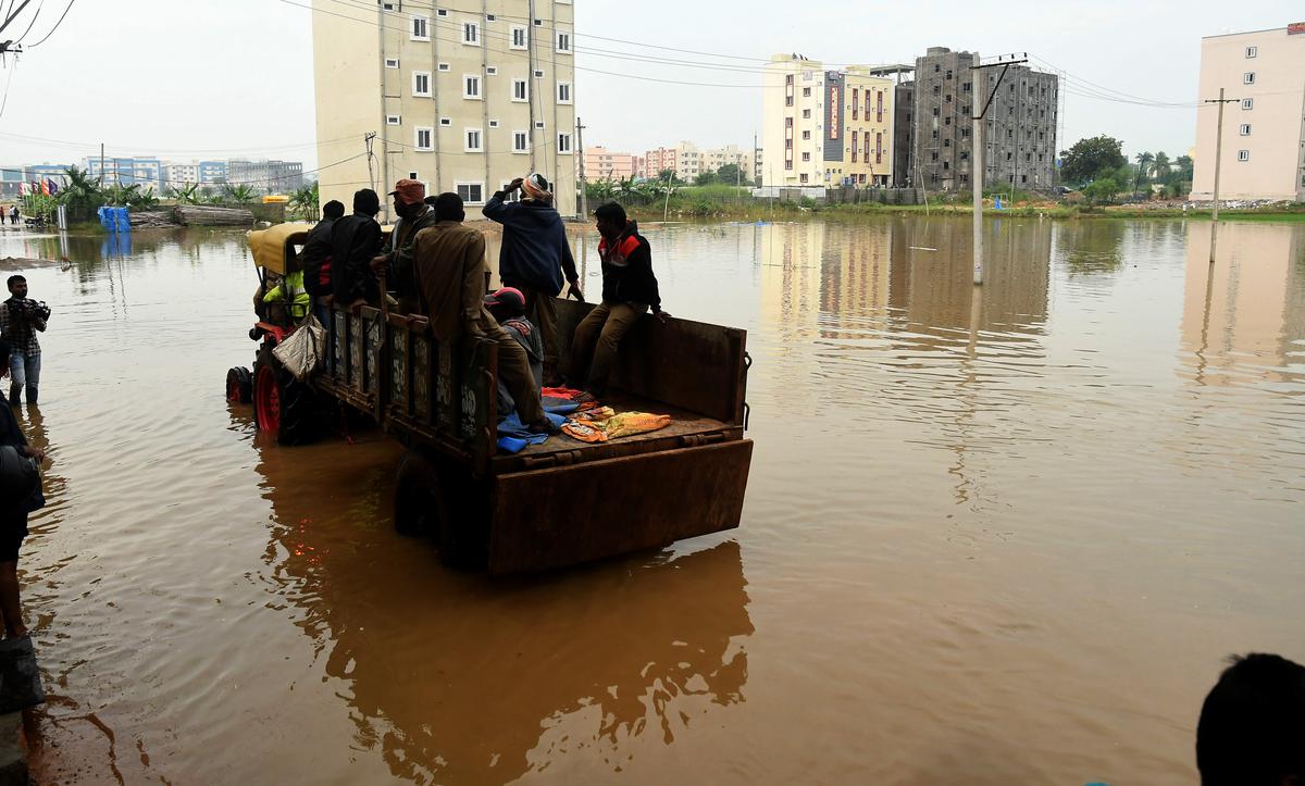 Students from hostels in Maisammaguda area near Dundigal being shifted to a safer place in a tractor, following heavy inundation of their hostel buildings in Hyderabad on Tuesday.