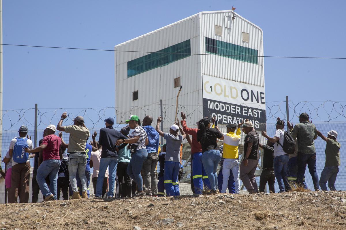 Miners gather at the top of a goldmine shaft in Springs, South Africa, on Tuesday’