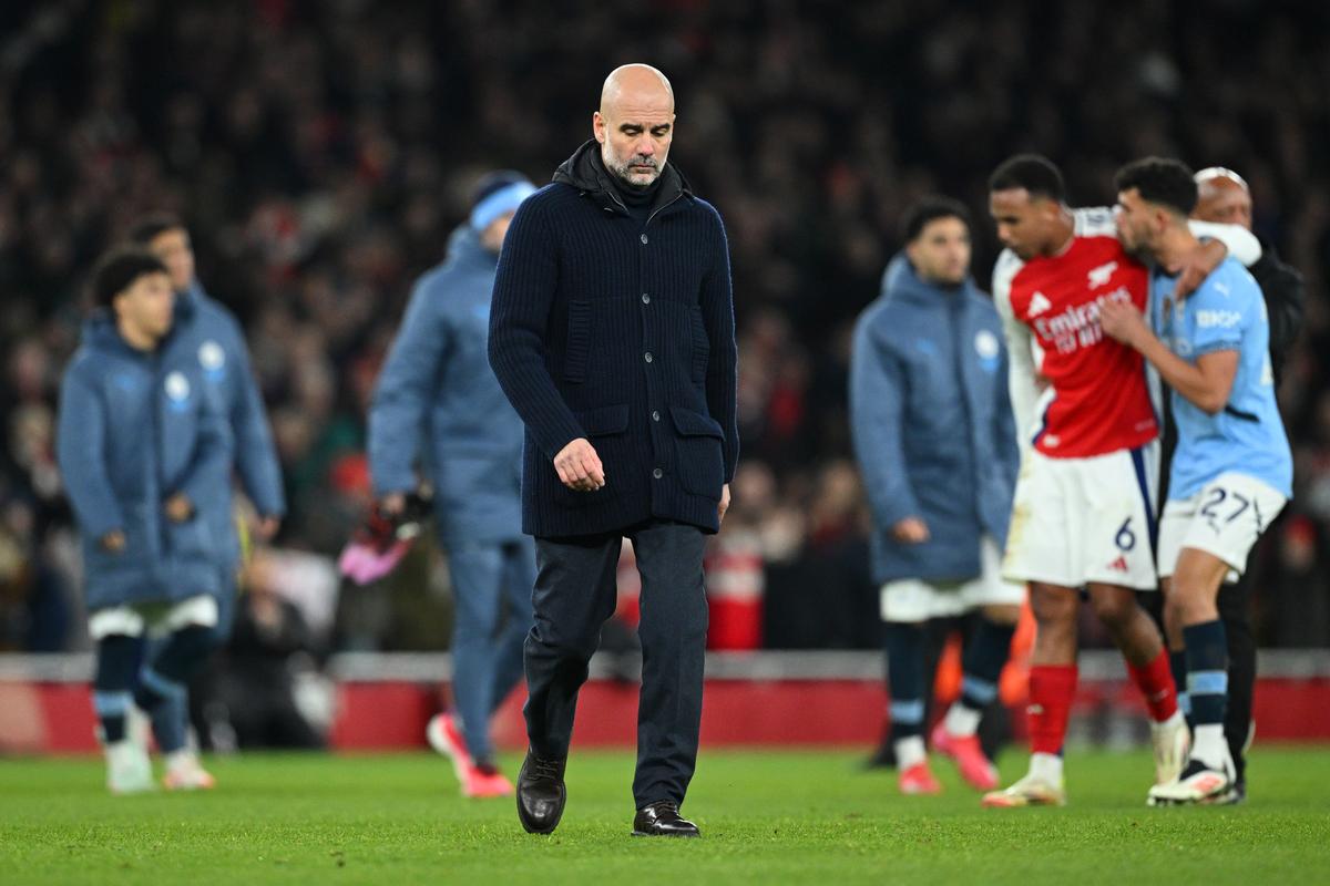 Pep Guardiola, manager of Manchester City, looks dejected as he leaves the pitch after defeat to Arsenal during the Premier League match between Arsenal FC and Manchester City FC at Emirates Stadium on February 2, 2025