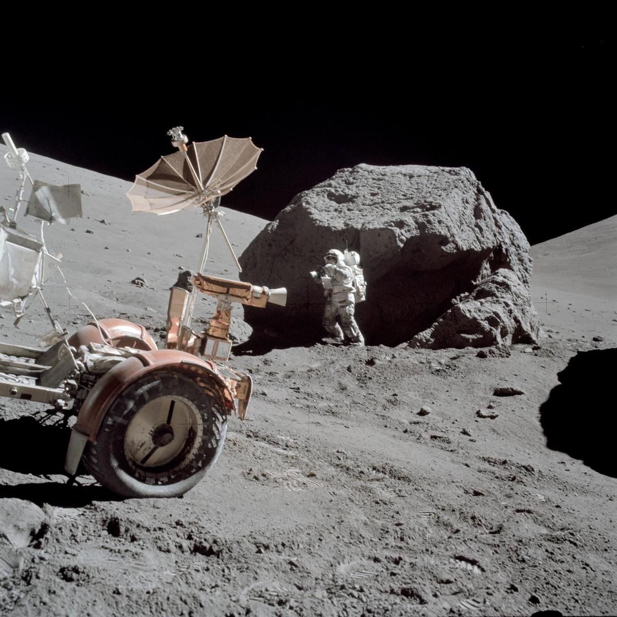 Scientist-astronaut Harrison H. Schmitt is photographed working beside a huge boulder at Station 6 (base of North Massif) on the moon during the Apollo 17 expedition in 1972