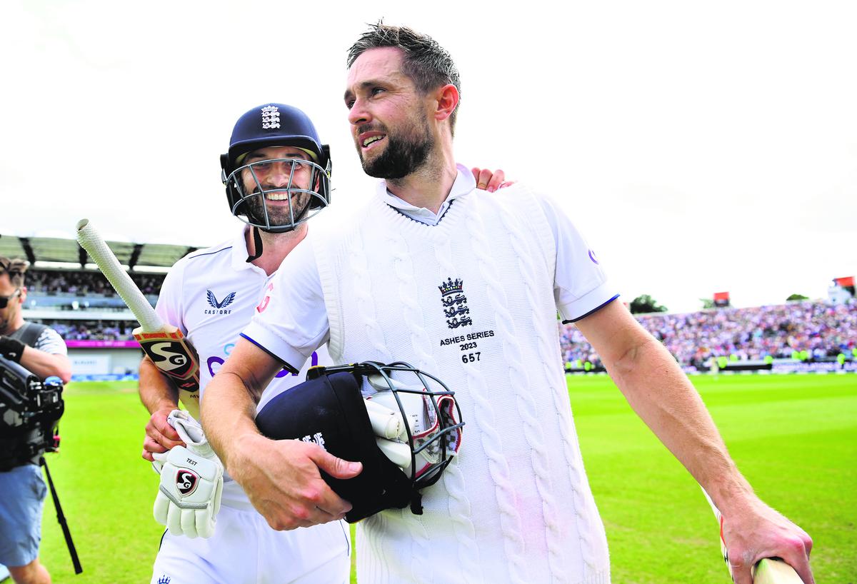 Chris Woakes celebrates as he leaves the field with teammate Mark Wood after hitting the winning runs.