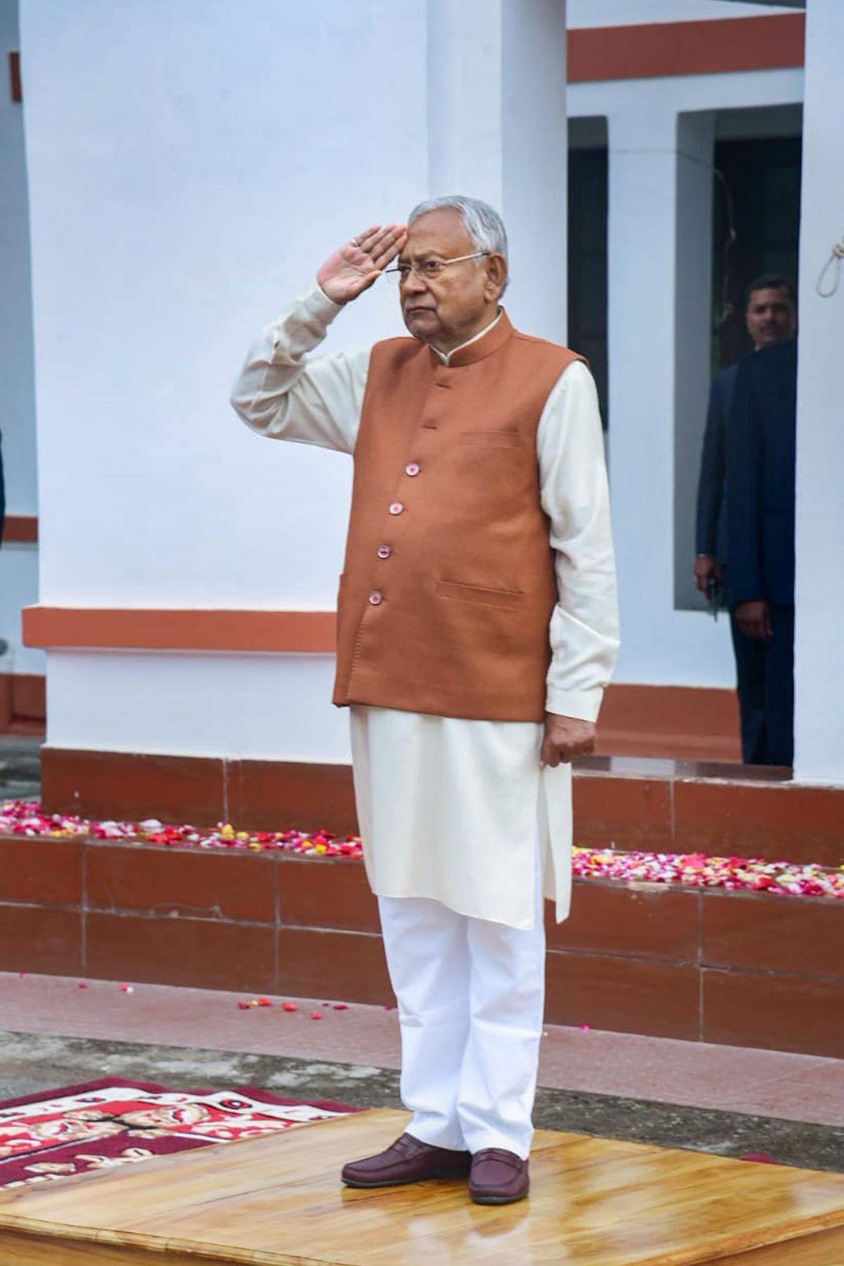 Bihar Chief Minister Nitish Kumar salutes after hoisting the national flag during the 74th Republic Day celebrations, at his official residence in Patna, on Jan. 26, 2023. 