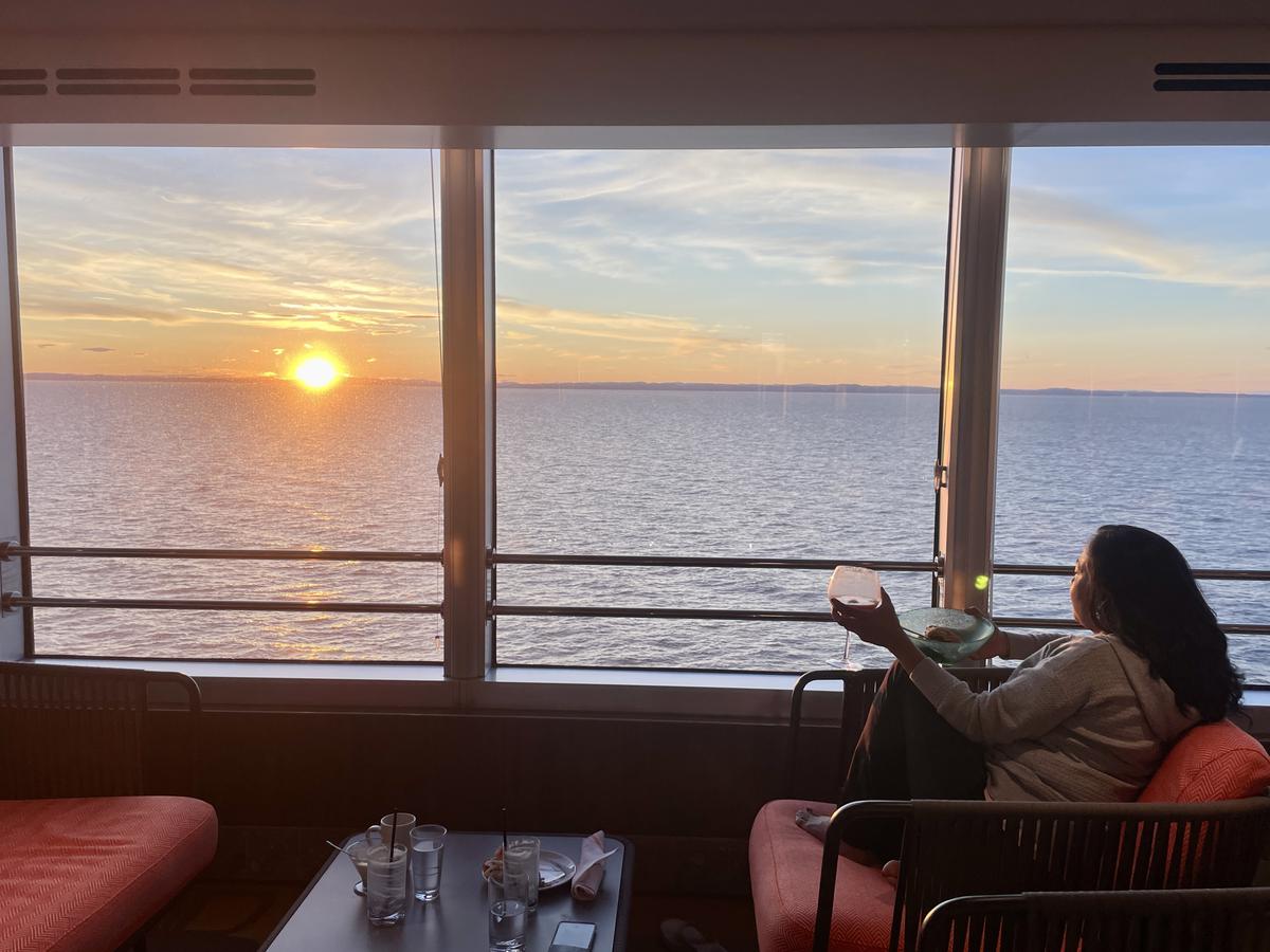 Author Rachna Bisht watches the midnight sun from her cabin during her cruise to Norway. 