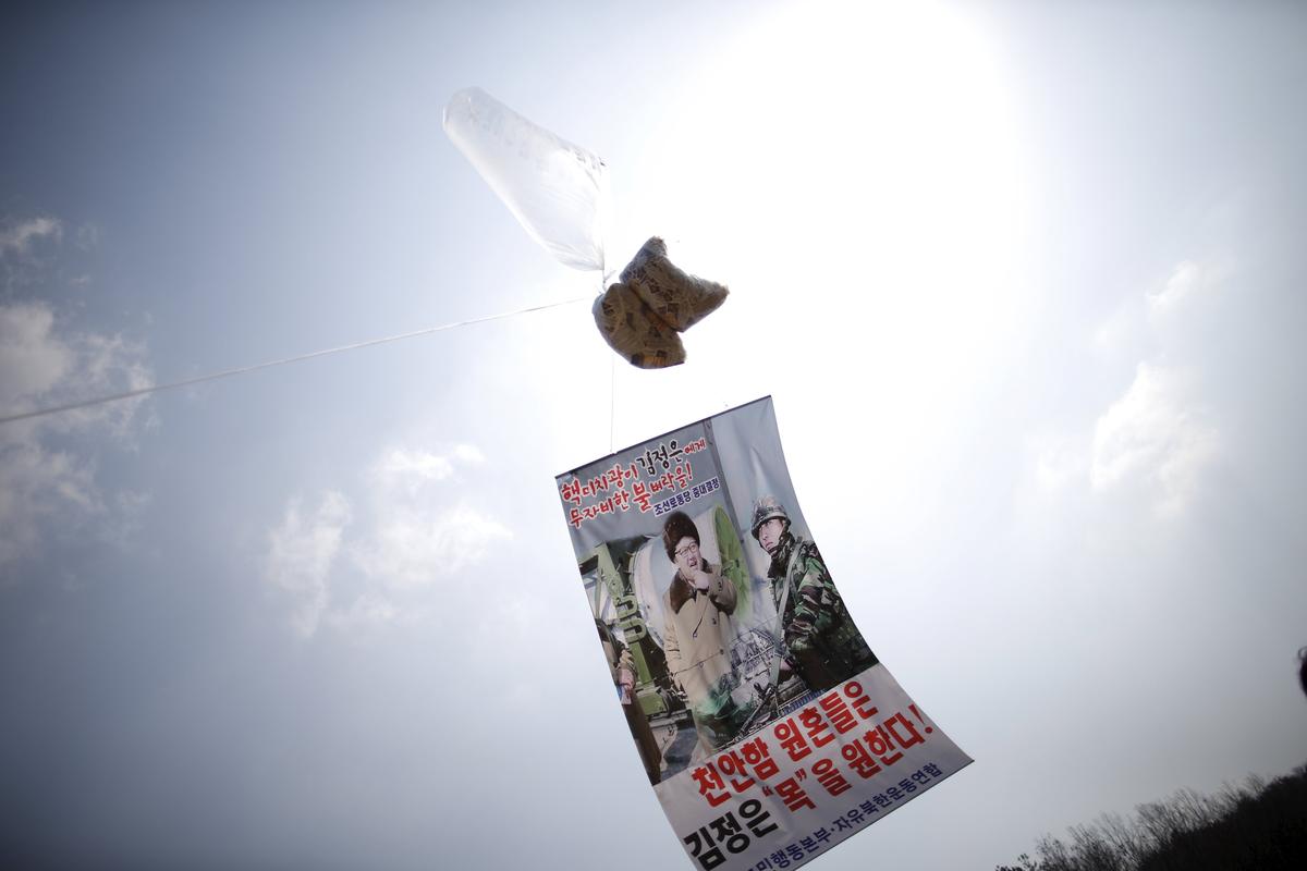 A balloon containing leaflets denouncing North Korean leader Kim Jong Un is seen near the demilitarized zone separating the two Koreas in Paju, South Korea, March 26, 2016, on the sixth anniversary of the sunken naval ship Cheonan. The lettering on the banner reads 'Merciless attacks on nuclear addict Kim Jong Un' (top) and 'Sprits of deceased 46 navy sailors on the sunken naval ship Cheonan want Kim Jong Un's life.' (bottom). REUTERS/Kim Hong-Ji