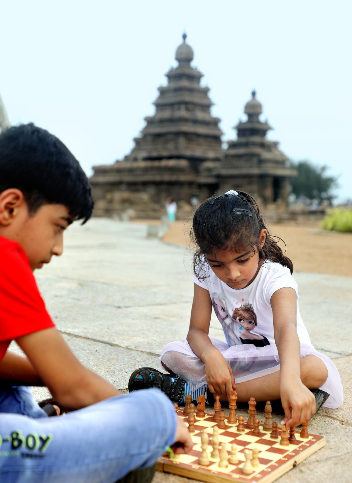 Children play chess near the Shore Temple at Mamallapuram near Chennai