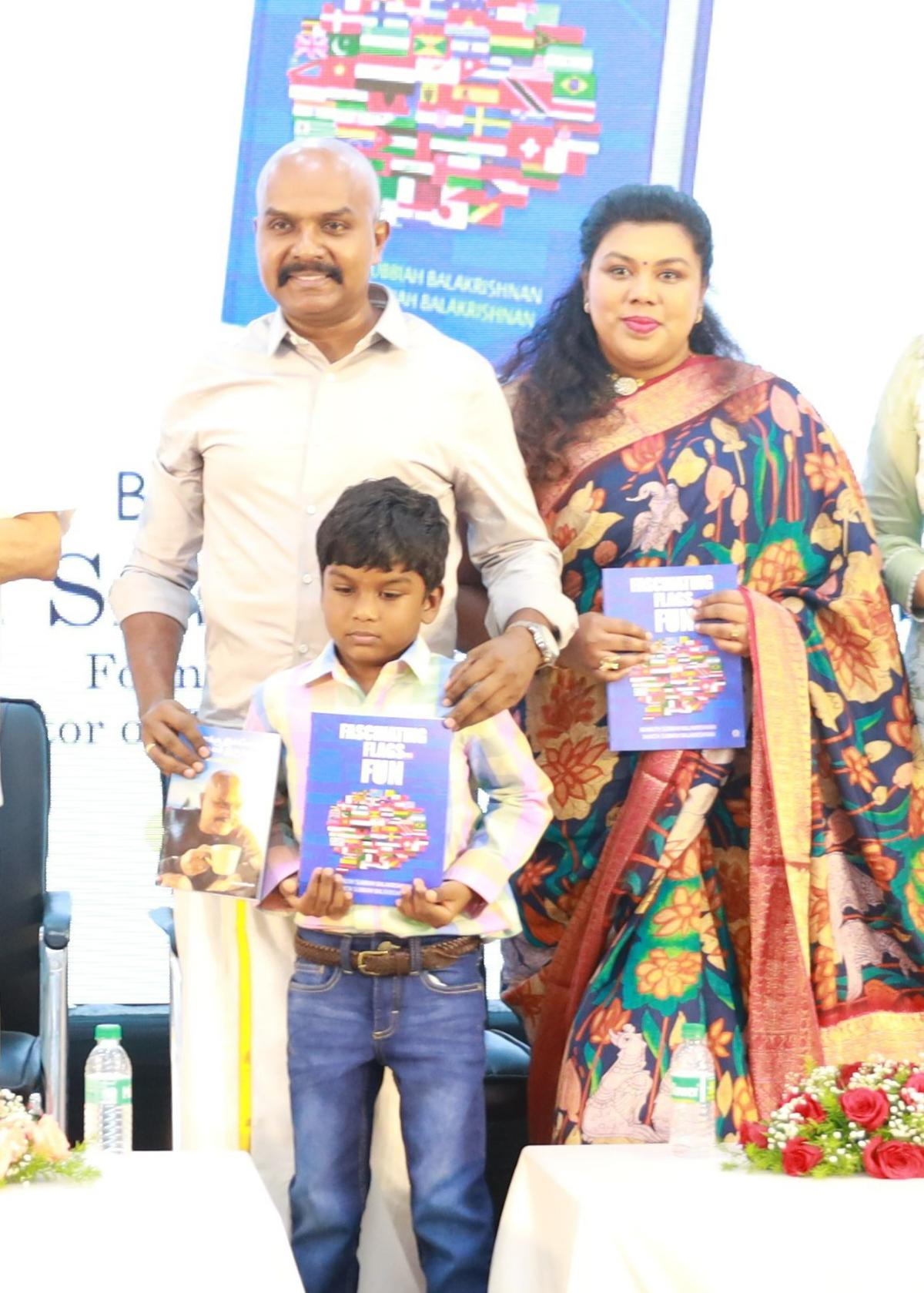 V Balakrishnan IPS along with his wife Shweta and son Adhruth holding their new book on flags 