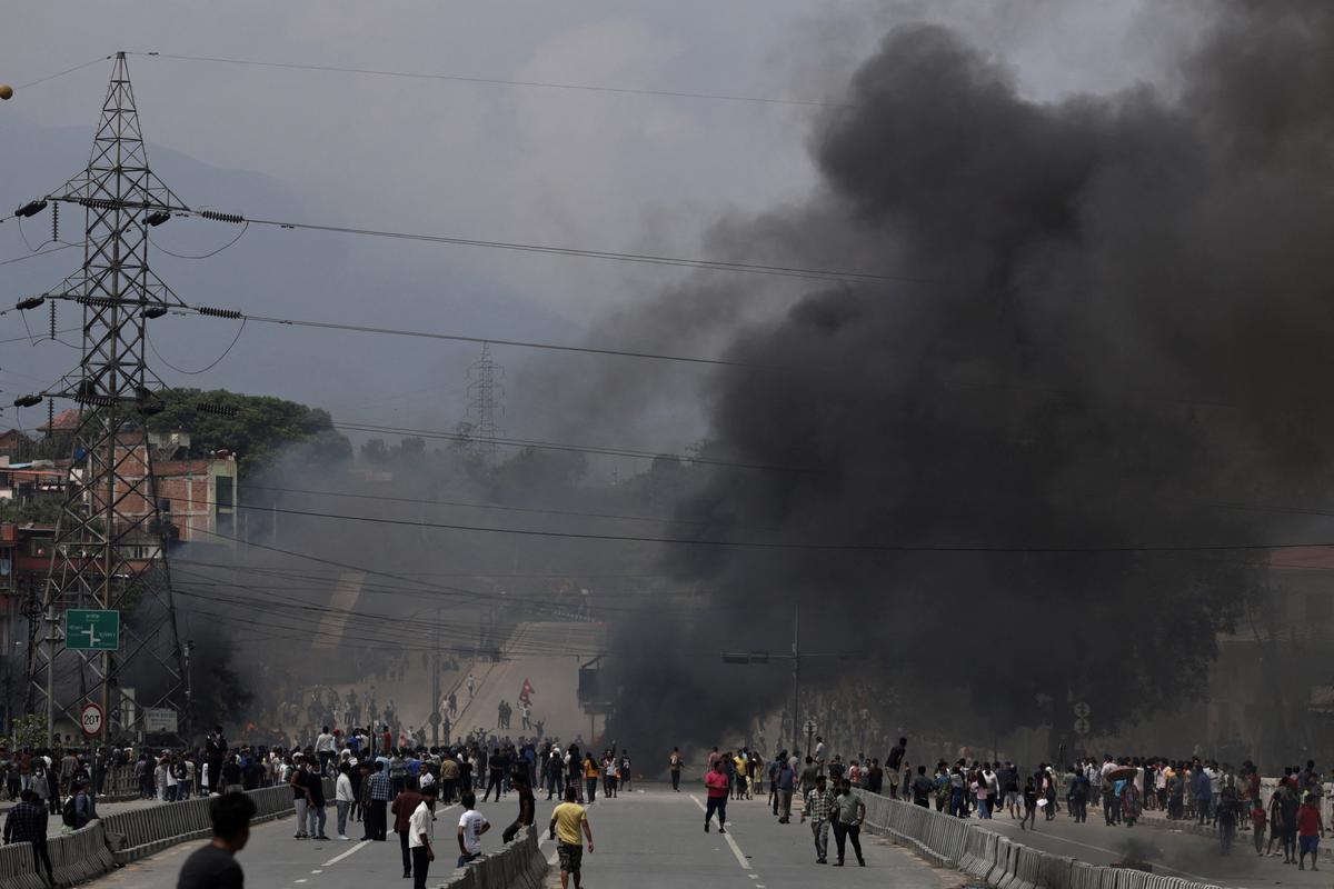 Smoke rises as demonstrators gather to protest against Monday’s killing of 19 people after anti-corruption protests that were triggered by a social media ban which was later lifted, during a curfew in Kathmandu, on September 9, 2025.