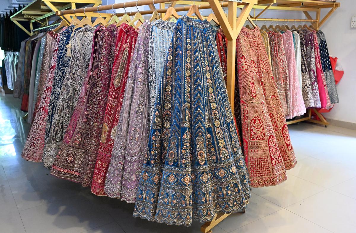 Heavily worked lehengas in vibrant tones on display at Sasha The Bridal Rental Boutique in Madurai. 