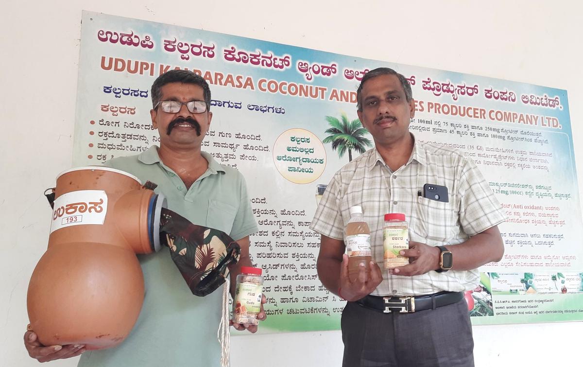 K. Sathyanarayana Udupa, President-cum-Managing Director, UdupiKalparasa Coconut and All Spices Producer Company Ltd (right) andMuralidhara Ullura, a Chartered Accountant and an advisor to the FPC(left) with the Coco-sap Chiller developed by the CPCRI for tapping ‘neera’ and some value-added products of ‘neera’ made by the FPC.