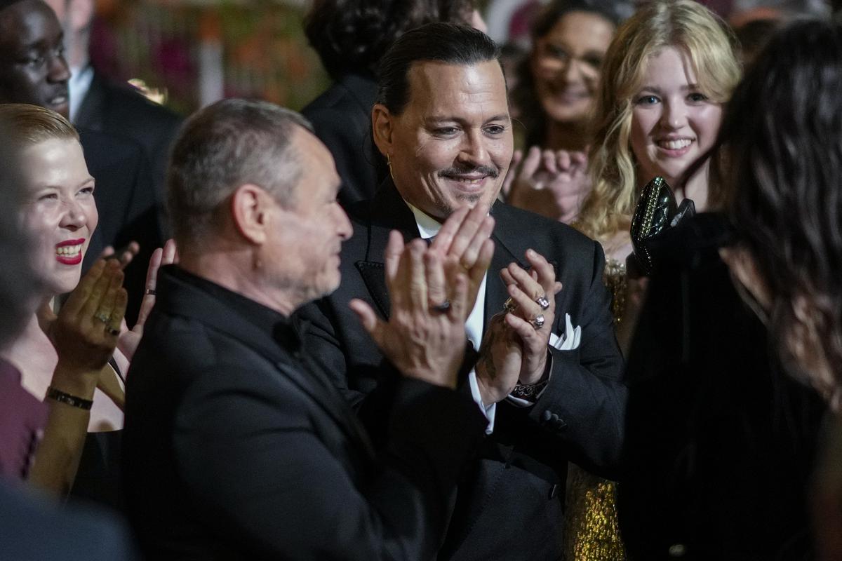 Johnny Depp, centre, poses for photographers upon departure from the premiere of the film ‘Jeanne du Barry’ at the 76th international film festival, Cannes