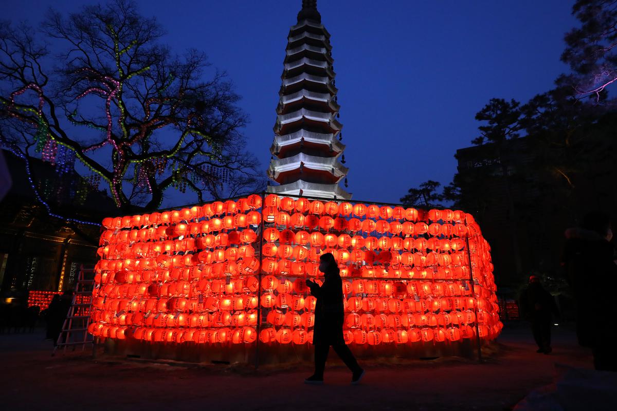 A woman prays at Jogye temple during New Year’s Eve on December 31, 2022, in Seoul, South Korea. South Koreans will celebrate in central Seoul after the New Year event was held without an audience for the past three years due to the COVID-19 pandemic. 
