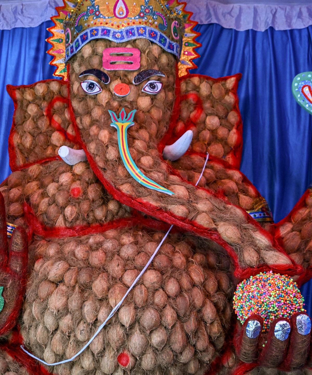 A 12 feet high Ganesha idol made with 900 coconuts as part of an eco-friendly initiative at CMR in Visakhapatnam. A 12 feet high Ganesha idol made with 900 coconuts as part of an eco-friendly initiative at CMR in Visakhapatnam.