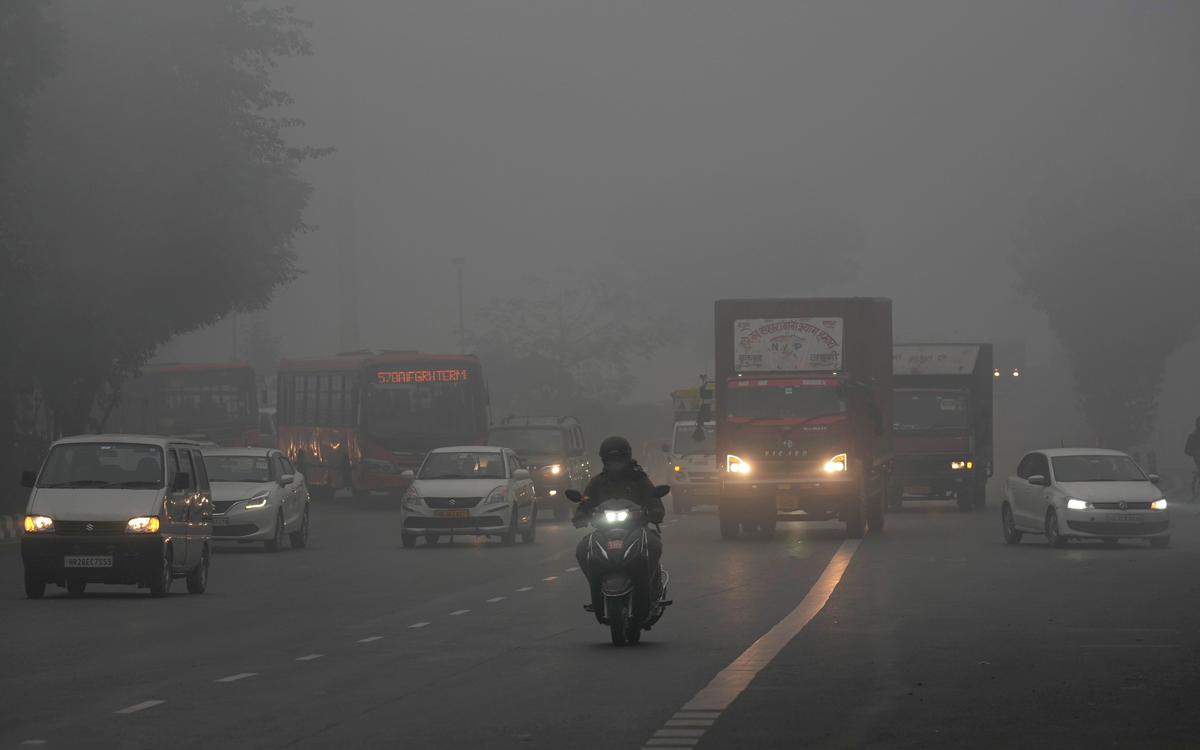 Vehicles ply on road amid low visibility during fog on a cold winter morning, in New Delhi on January 14, 2024.