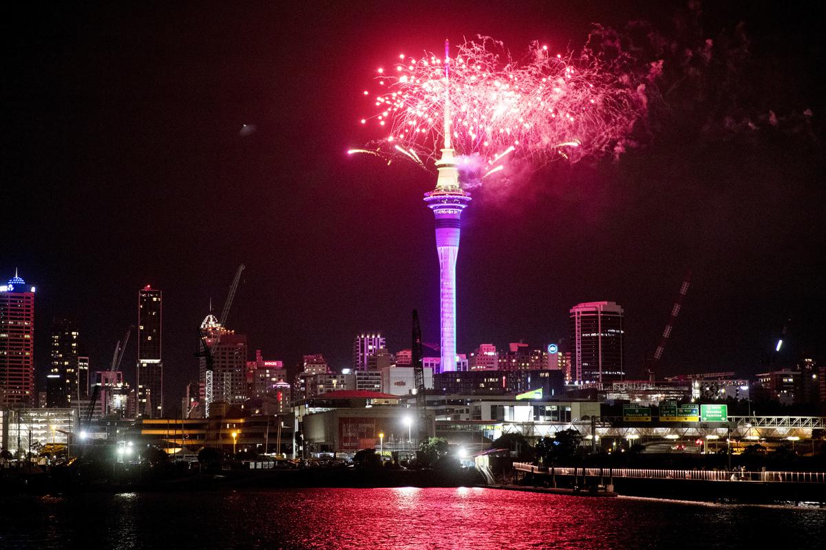 Fireworks explode over Sky Tower in central Auckland as New Year celebrations begin in New Zealand on January 1, 2023.