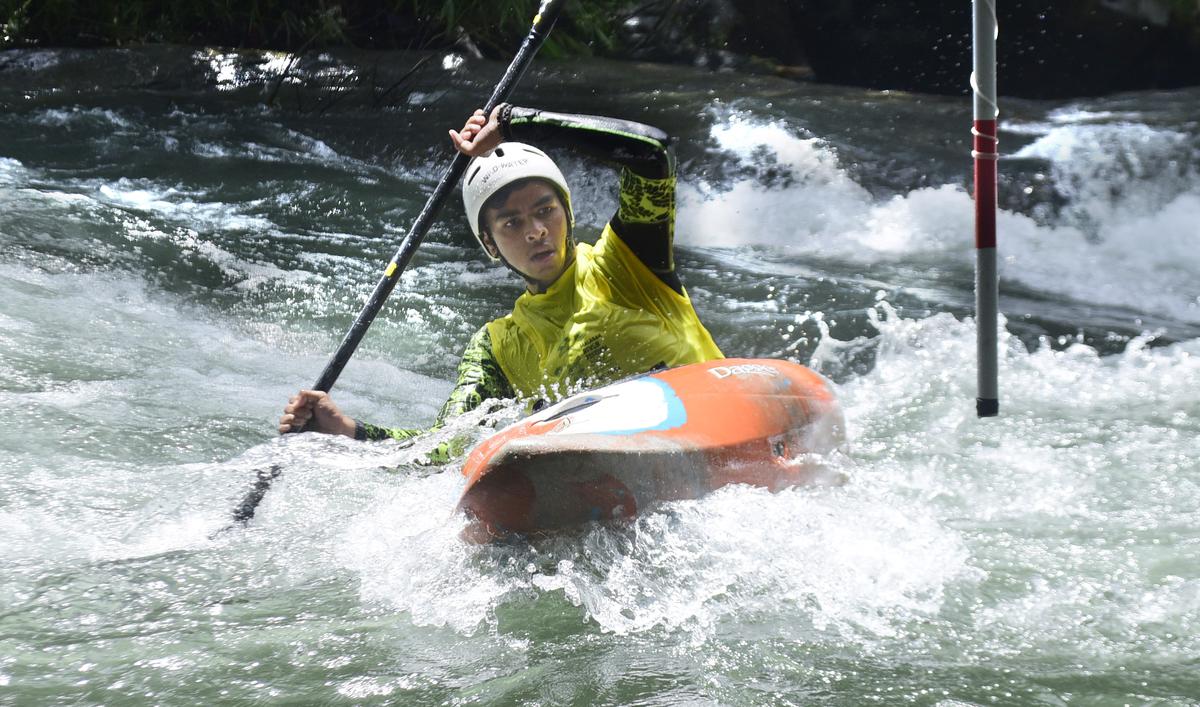 A paddler tries to safely cross one of the downstream gates in the Chalippuzha river while proceeding to the finishing point at the international white-water kayaking event in Kozhikode on Friday.