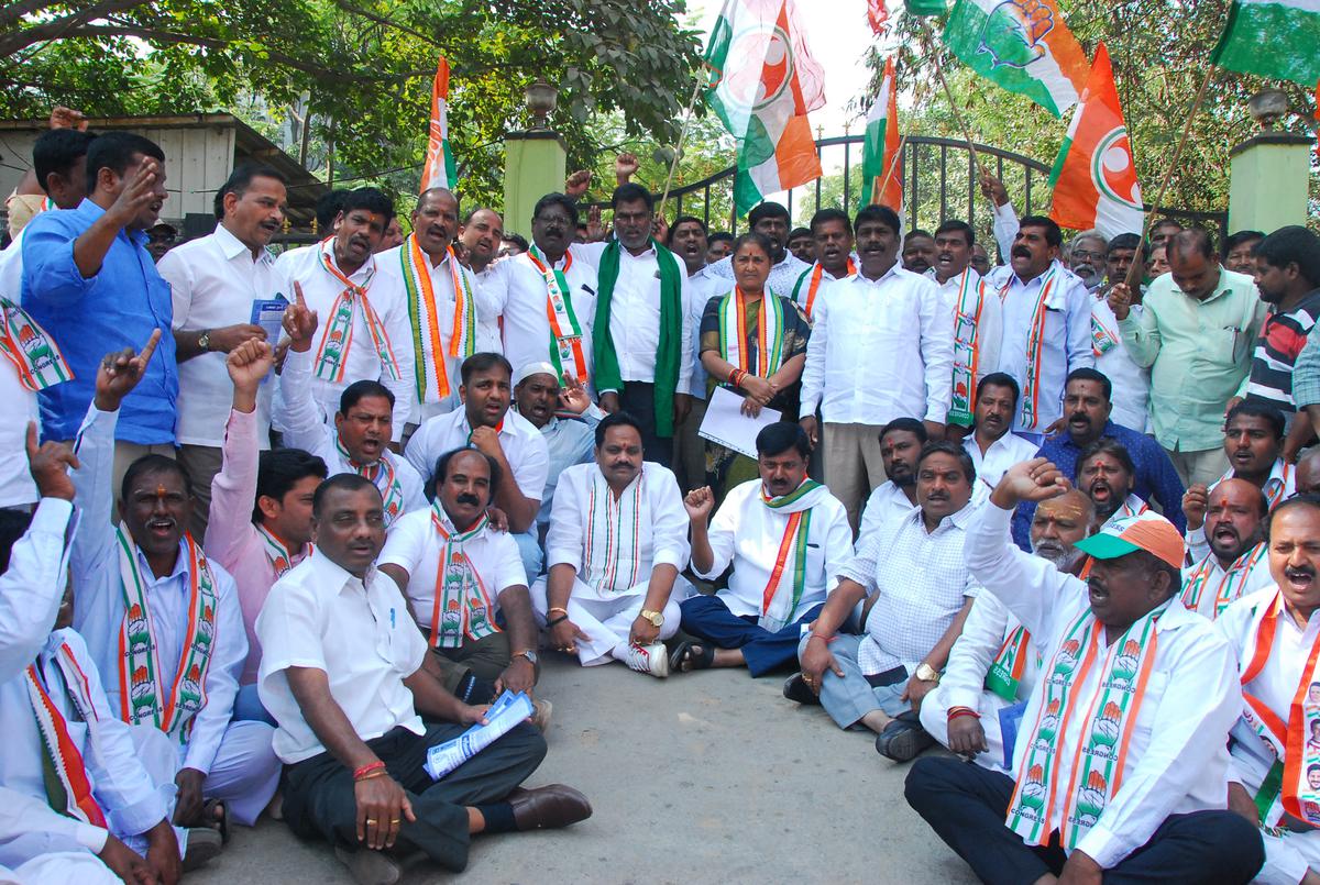 Congress party cadre staging a protest in front of Collector office in Sangareddy on Monday.