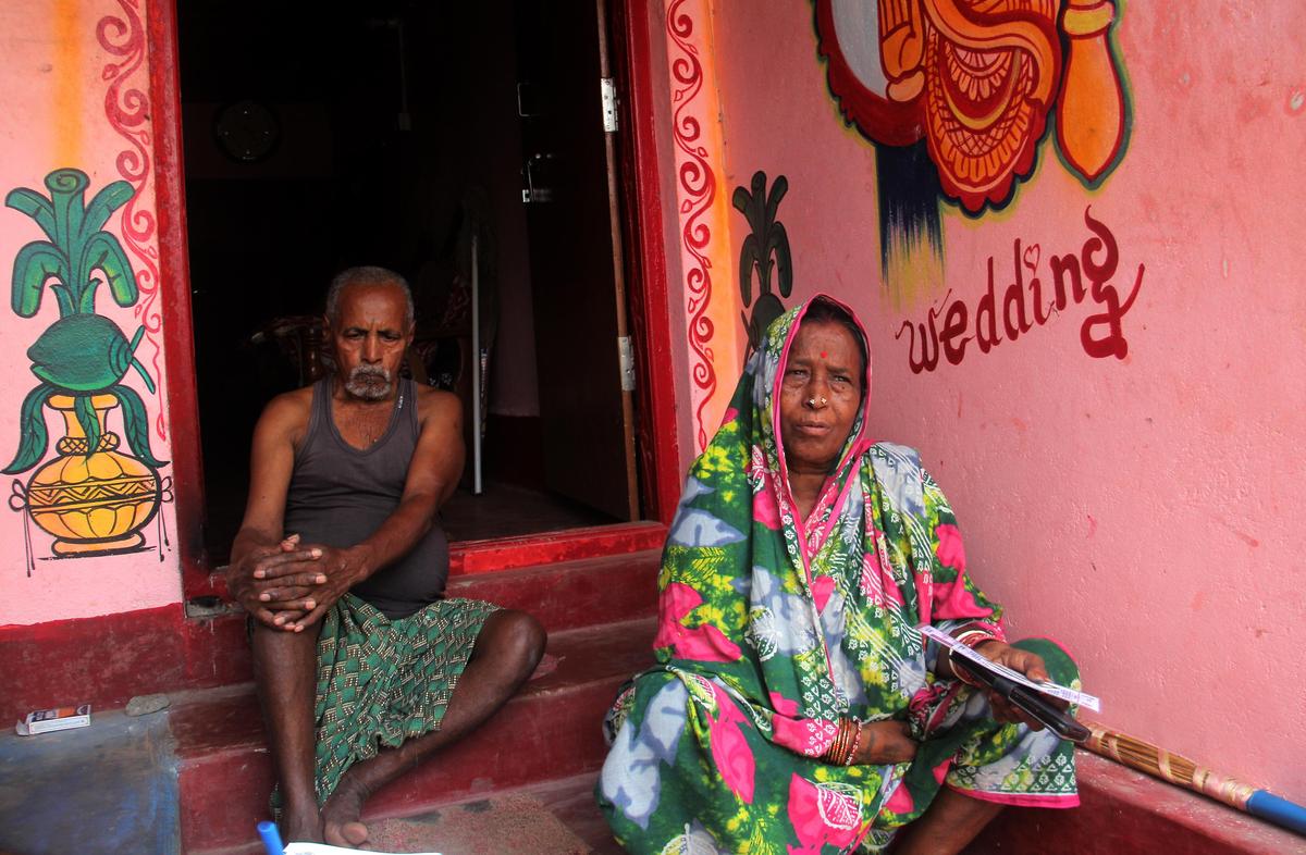 Old parents of a family are seen at their house as their two sons are stranded in Gulf region for work at Manikapur in Ganjam district of Odisha.