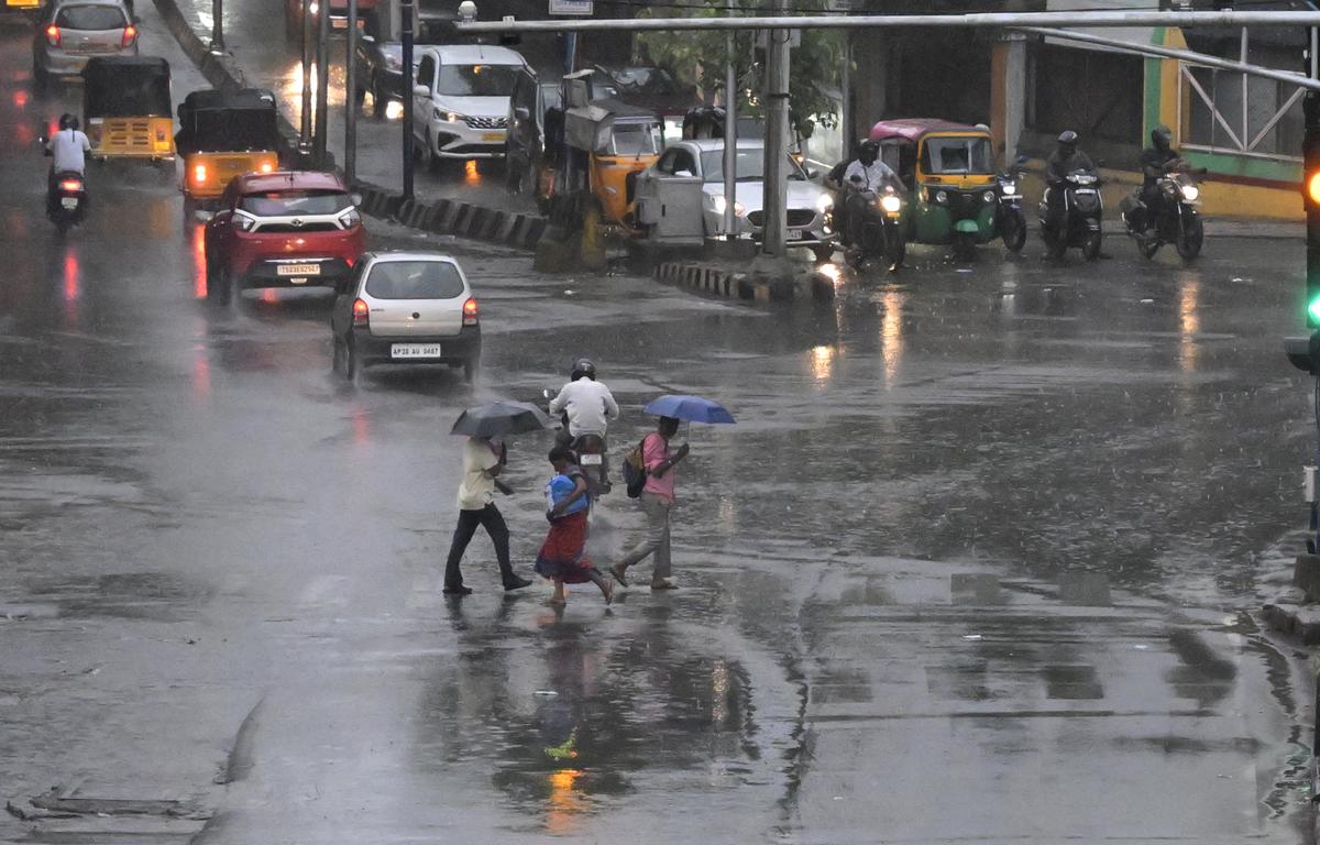 Commuters and pedestrians crossing the road as heavy rain lashes the twin cities on Sunday. Commuters and pedestrians crossing the road as heavy rain lashes the twin cities on Sunday.