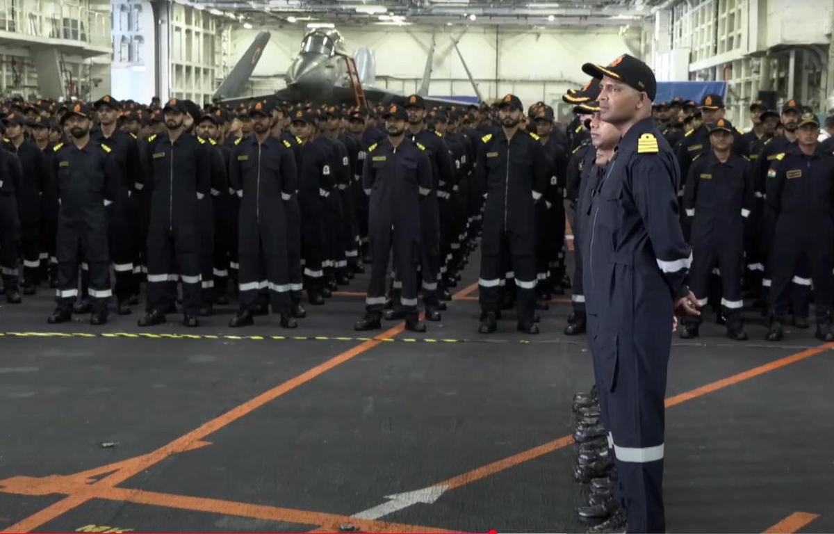 Indian Navy personnel listen to Prime Minister Narendra Modi's address during Diwali celebration aboard INS Vikrant Indian Navy personnel listen to Prime Minister Narendra Modi's address during Diwali celebration aboard INS Vikrant