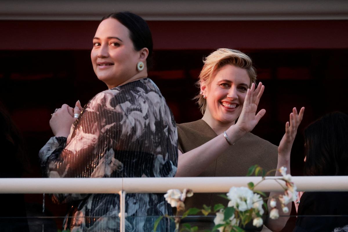 Greta Gerwig, Jury President of the 77th Cannes Film Festival, and jury member Lily Gladstone stand on the balcony at the Hotel Martinez on the eve of the opening of the 77th Cannes Film Festival in Cannes