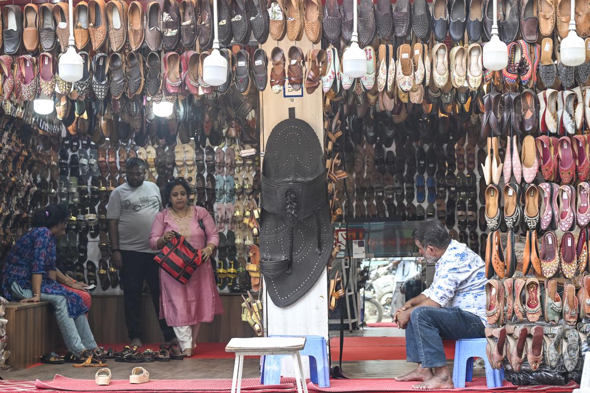 Visitors shop Kolhapuri Chappals  inside a store in Chappal market in Kolhapur