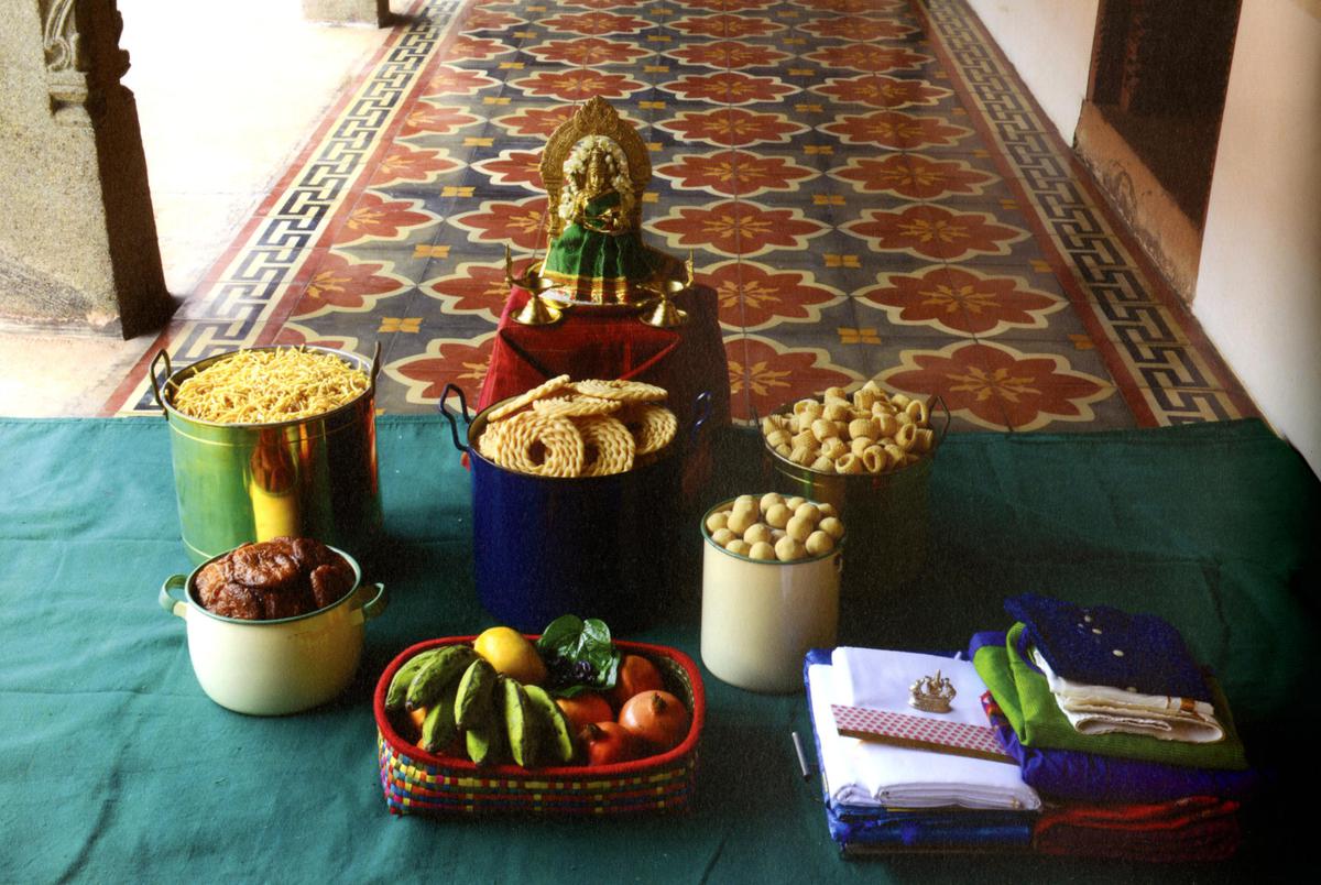 A picture from a book displaying sweets and namkeen prepared for the first Diwali of a newly married couple